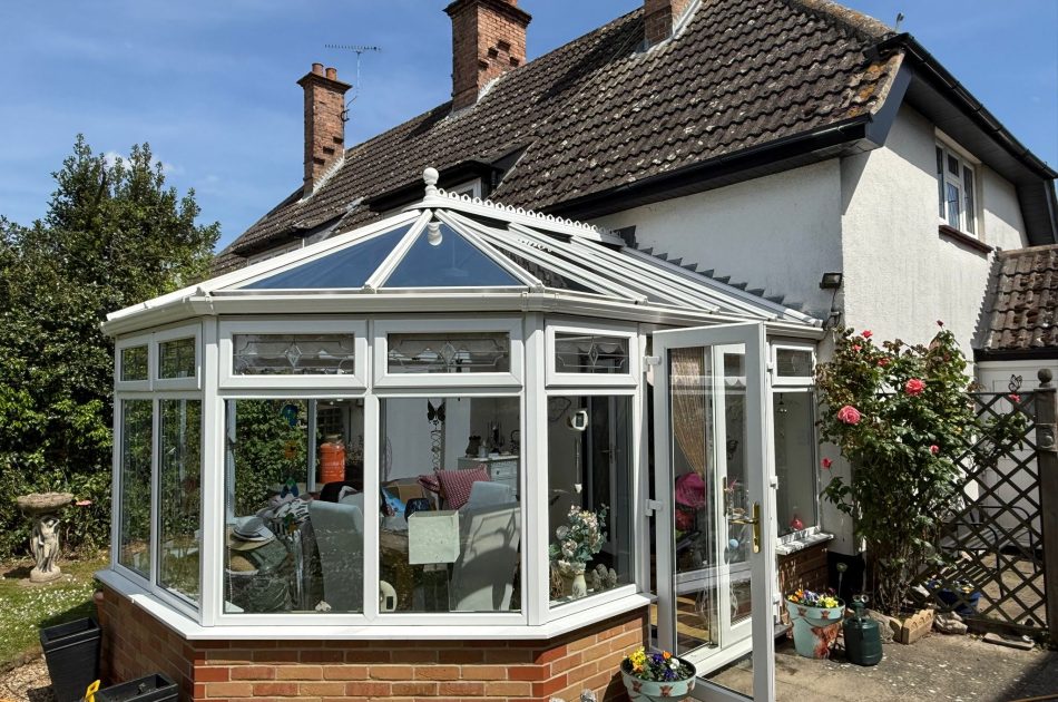 Professionally cleaned glass conservatory roof and white framework at a home in South Holland
