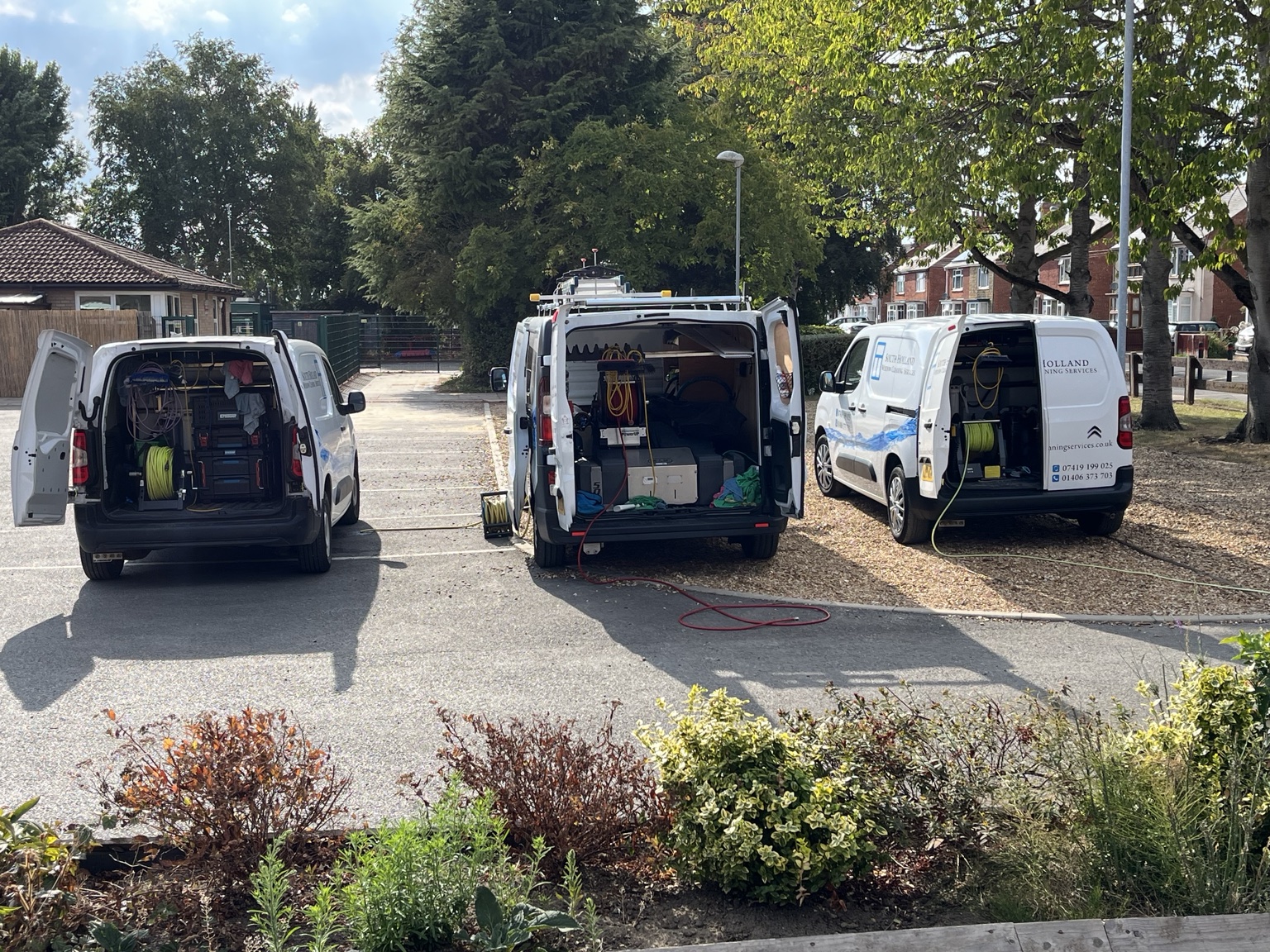 Three South Holland Window Cleaning Services vans on site for a primary school window clean in Spalding